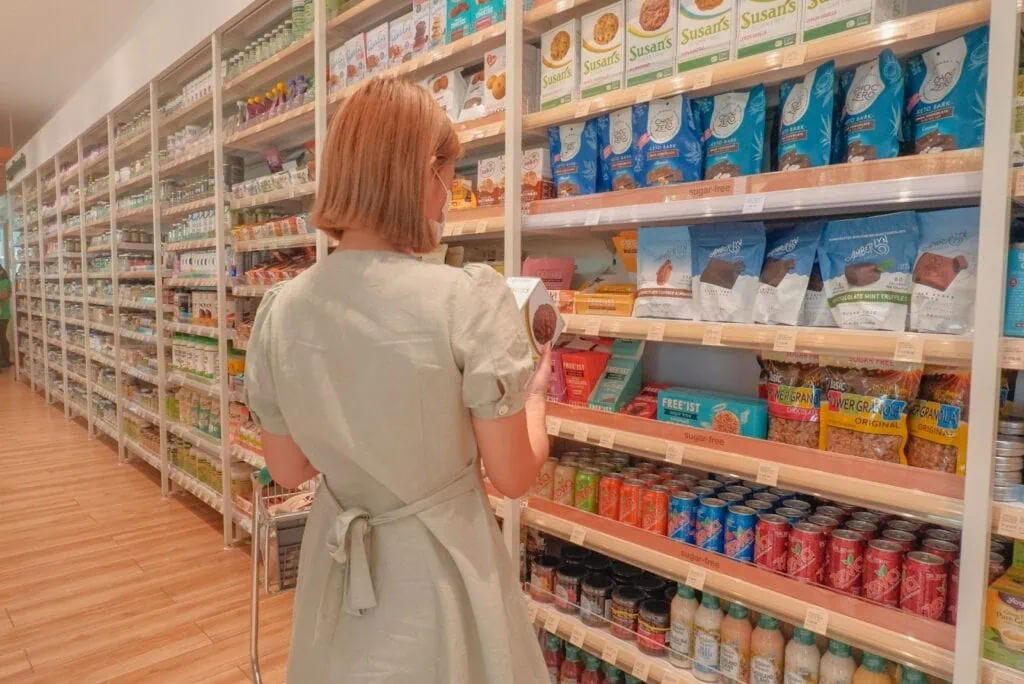 https://unsplash.com/photos/a-woman-in-a-white-dress-is-looking-at-a-shelf-of-food-byh0LHJFvjg?utm_content=creditCopyText&utm_medium=referral&utm_source=unsplash